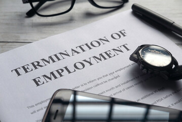 termination of employment paper with glasses and watch